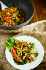 Warm summer salad of fried vegetables with tomatoes