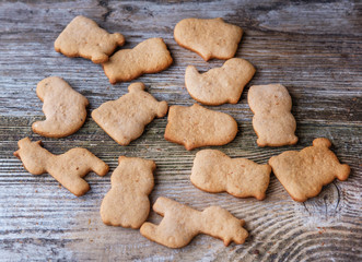 ginger cookies in the form of animals on wooden background
