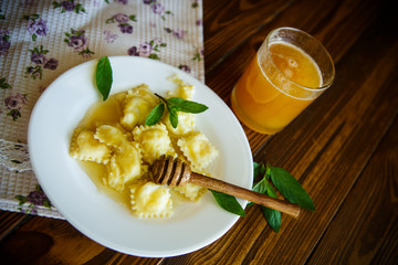 Homemade sweet ravioli with cottage cheese and honey