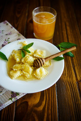 Homemade sweet ravioli with cottage cheese and honey