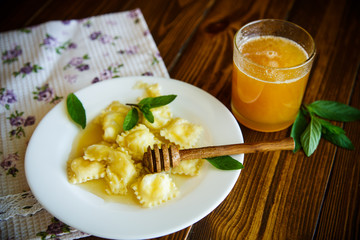Homemade sweet ravioli with cottage cheese and honey