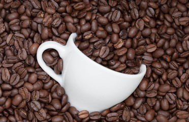 Cup in coffee beans