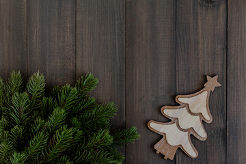 Christmas fir tree branches and tree ornament on dark rustic wooden background with copy space for...