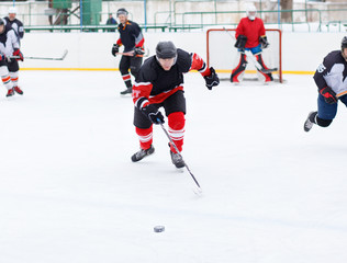 Fototapeta na wymiar Ice hockey skater with stick in counterattack.