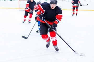 Ice hockey skater with stick in counterattack.