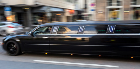 long luxury limousine speeding in the city - obrazy, fototapety, plakaty