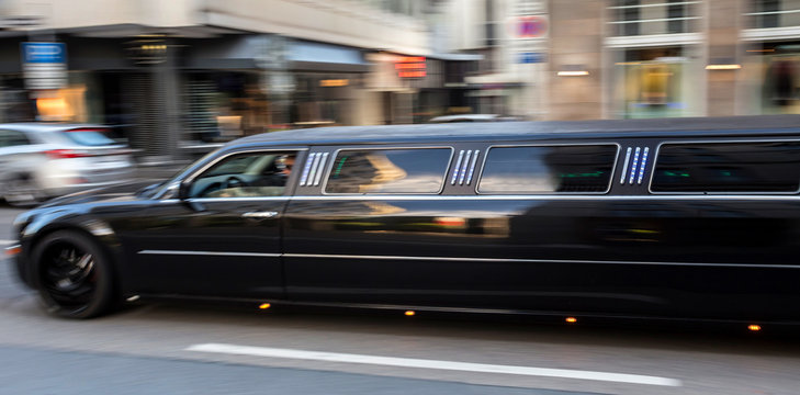 long luxury limousine speeding in the city