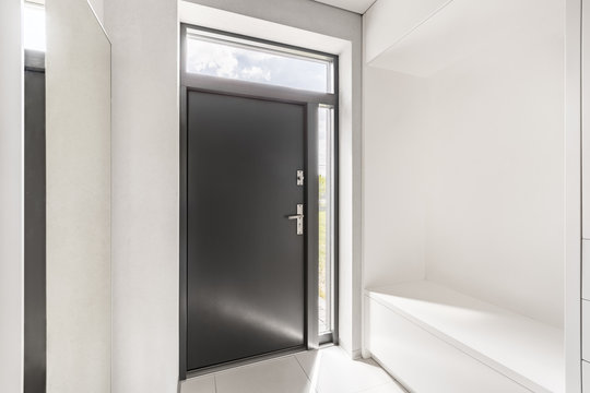 White Entryway With Gray Door