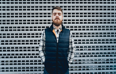 Handsome bearded man in casual clothes posing on camera