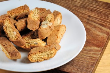 Dry biscuits "cantuccini". Typical product of Tuscan cuisine (Italy). Prepare with almonds and honey. On wooden background.