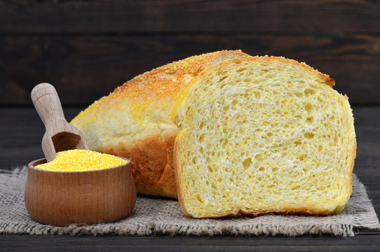 Cornbread and corn flour on wooden background