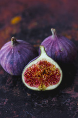 Beautiful and fresh figs on rusty surface. Half of fig.
