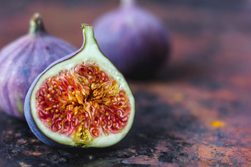 Beautiful and fresh figs on rusty surface. Half of fig.