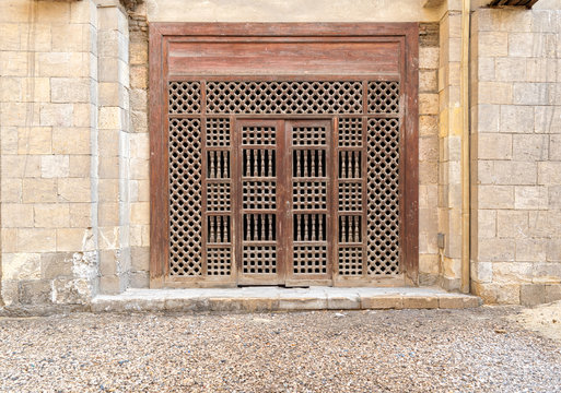 Wooden ornate door over stone brick wall, Old Cairo, Egypt