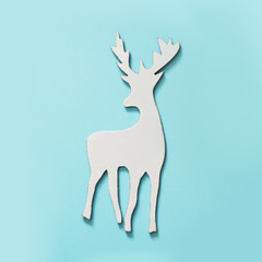 White Christmas reindeer with antlers on blue hipster background. Flat lay. New Year concept.