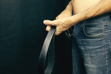 A strict father holds the girdle, the concept of violence © Artvibe