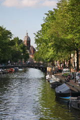 Oudezijds Voorburgwal embankment and church of Saint Nicholas in Amsterdam. Netherlands 