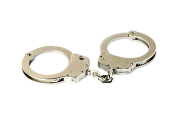 Steel handcuffs on a white
