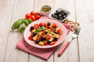 tofu salad with tomatoes black olives capers and pistachio