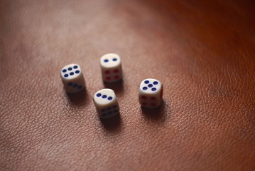 Plastic Dice on a leather surface