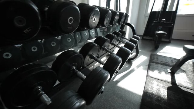 Rows of dumbbells in the gym, simulators for athletes.