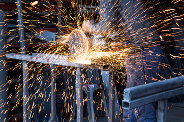 Concstruction worker cutting metal rod