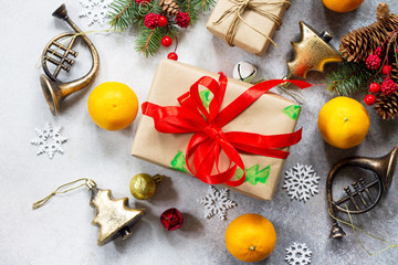 Christmas background. Christmas decor of a table, gifts and tangerines on a stone background. Flat lay, top view.