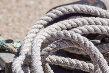 nautical rope rolled on the pier in a random way .