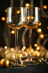 Glasses for wine and golden Christmas balls