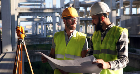 Portrait of construction engineers working on building site