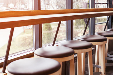 a row of chairs and a bar in the cafe