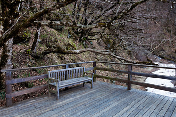 A place to relax with wooden decking and a bench. Resort Rosa Khutor, Sochi, Russia.