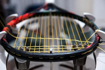 Zelfklevend Fotobehang Stringing tennis racquet on professional electrical stringing machine © ivananikolic
