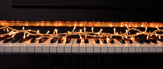 Christmas lights on a piano keyboard, front view