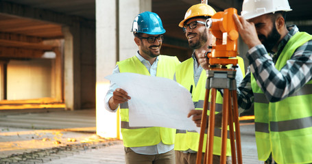 Fototapeta na wymiar Team of construction engineers working on building site
