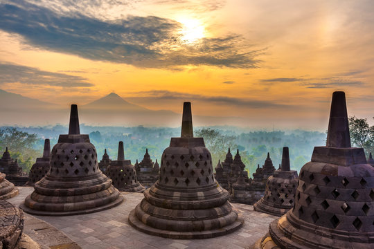 Taman Lumbini park from the height of the temple complex Candi Borobudur at sunrise in the fog. Candi Borobudur, Yogyakarta, Jawa, Indonesia.