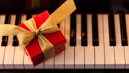 Christmas gift on a piano keyboard, above view © Rawf8