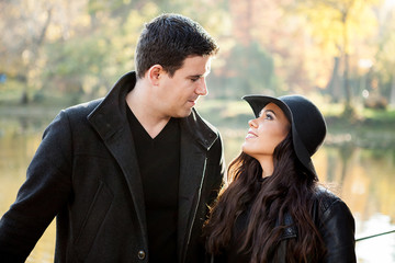 Beautiful gourgeous couple walking in an autumn park