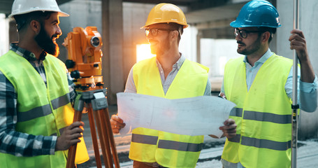 Portrait of construction engineers working on building site