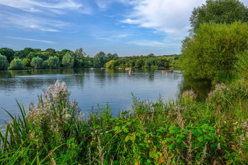 Boats on the lake in a country park on a summer day.