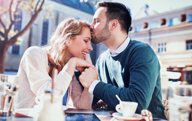 Romantic loving couple drinking coffee, having a date in the cafe. Dating, love, relationships