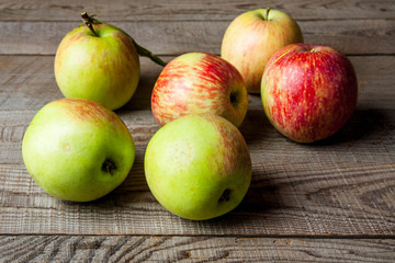 Ripe red apples on wooden background