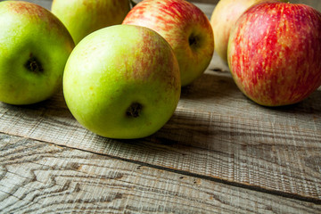 Ripe red apples on wooden background