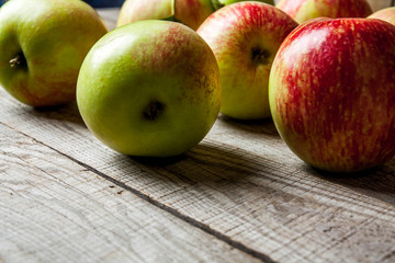 Ripe red apples on wooden background