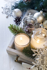 Burning candle and Christmas decoration