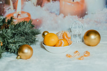 Fototapeta na wymiar Green tree, tangerines and Christmas