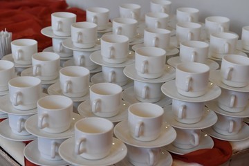 Empty white cups with plates 
