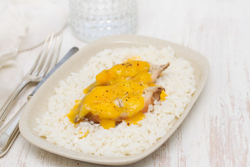 boiled fish with sauce and boiled rice on white dish