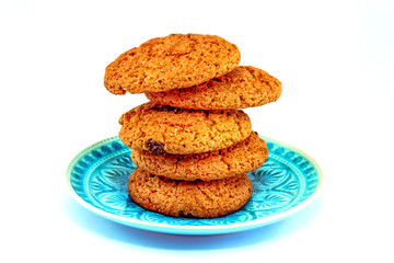 Close up of oatmeal cookies on the blue plate on white backgroun
