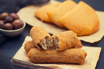 meat croquettes on paper on wooden background